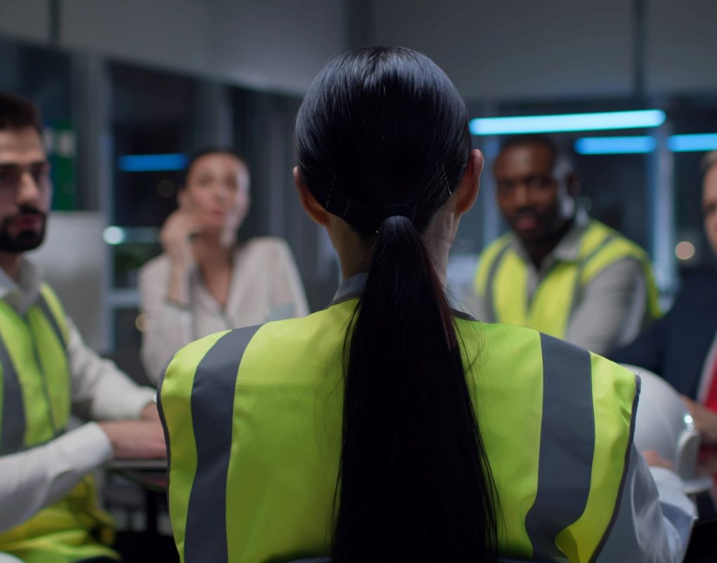 back-view-female-engineer-leading-meeting-with-contractors-modern-office