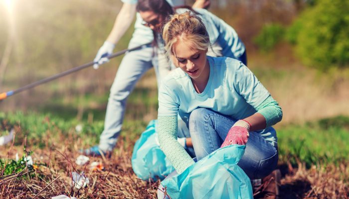 volunteers-with-garbage-bags-cleaning-park-area